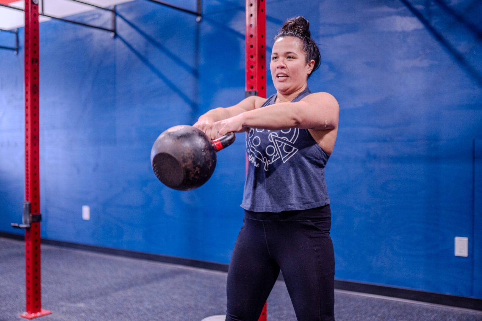 Woman doing kettlebell swings with proper form for injury prevention