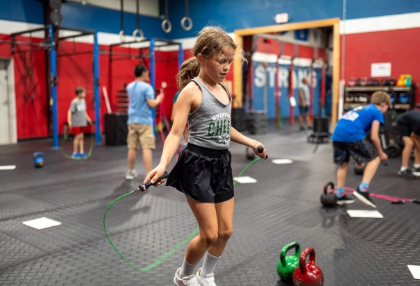 girl in grey shirt skips the hoop