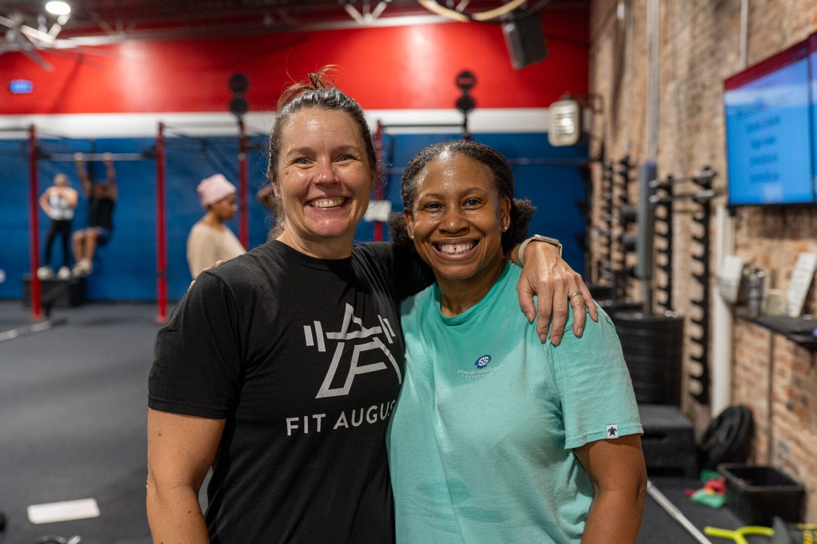 Fitness for Seniors in Downtown. Coach and member at Fit Augusta smile after training, showing supportive coaching and a fitness mindset.